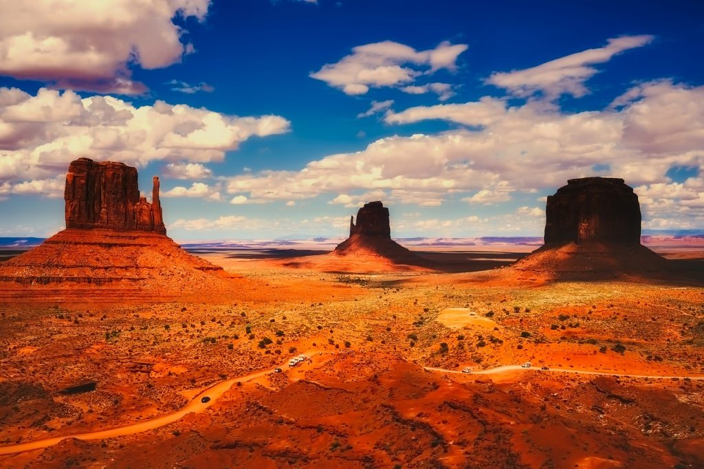 Monument Valley, Utah on a beautiful sunny day with hues of red and orange seen in the dunes