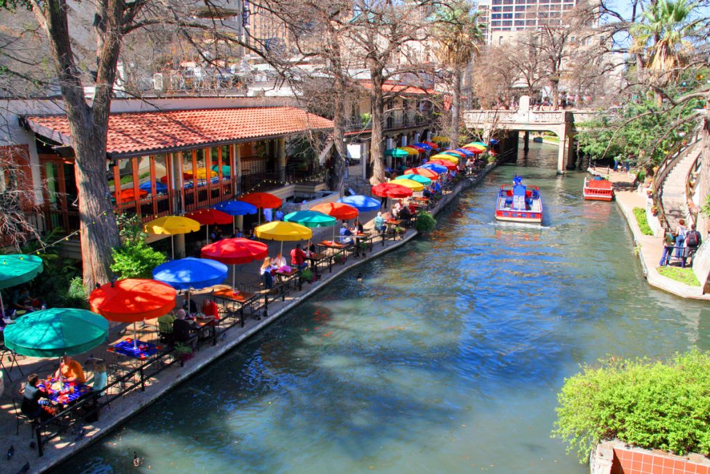 San Antonio River Walk with colorful umbrellas lining walkway in Texas