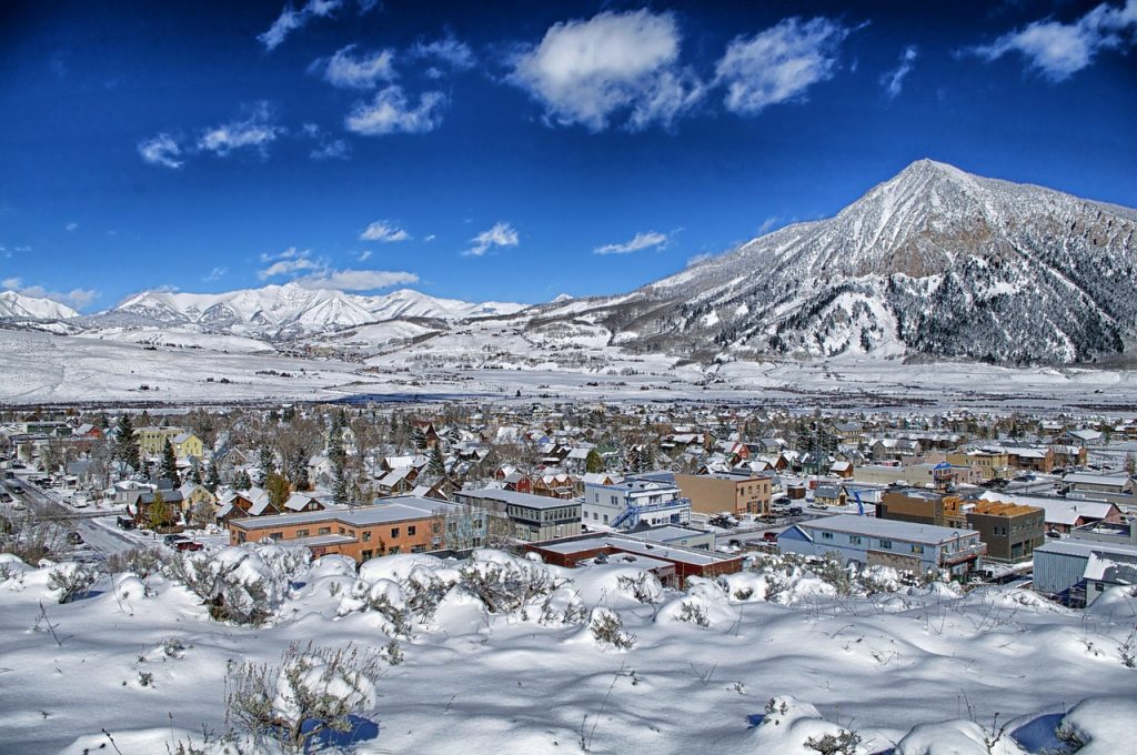 Crested Butte, Colorado, townview with snow covering everything and mountains in the background