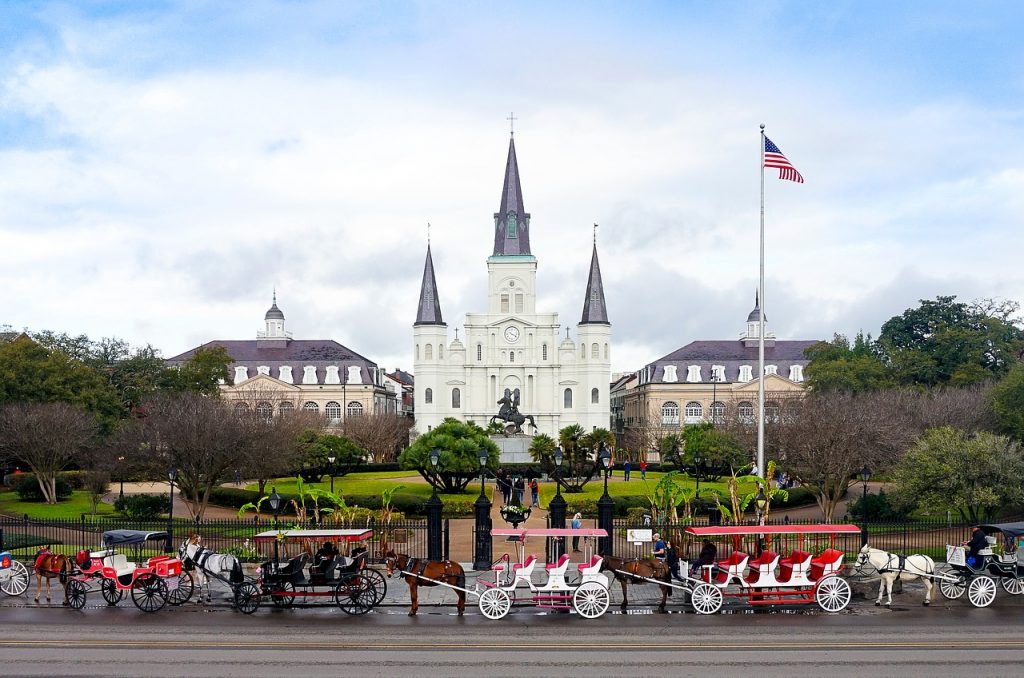 horse and carriages in front of Jackson Square in New Orleans