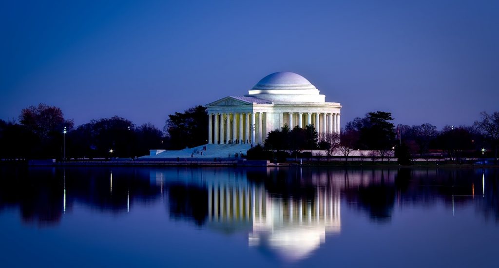 Jefferson Memorial in Washington DC at night time, with building reflection on the water