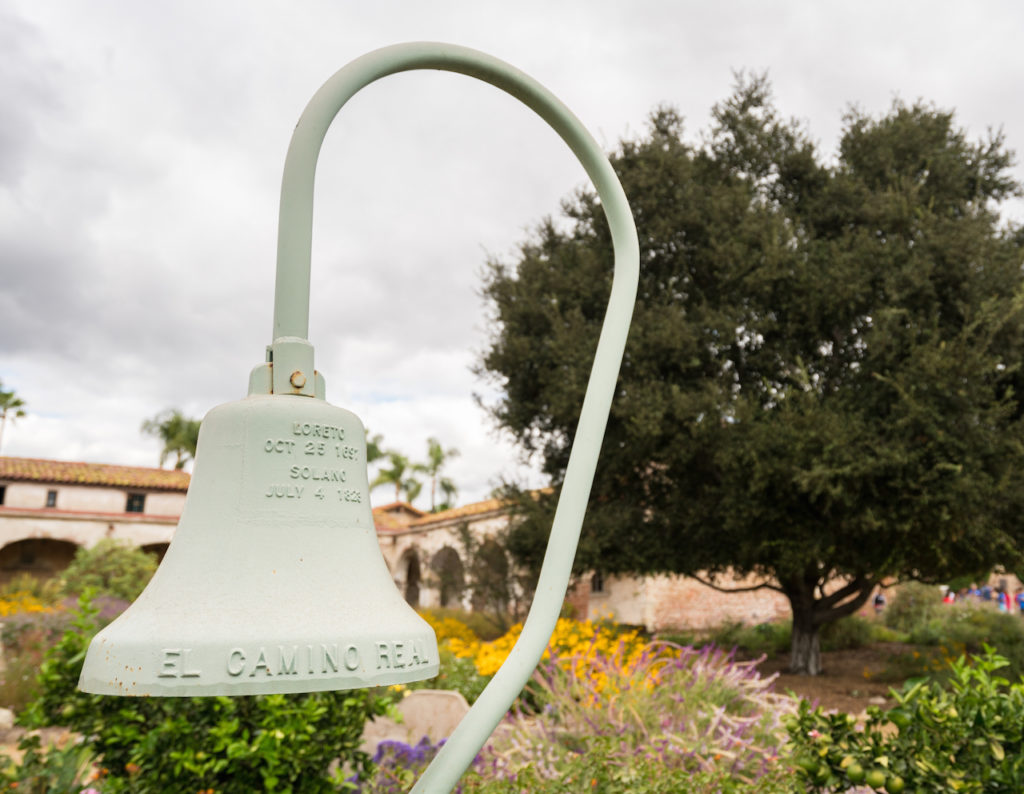El Camino Real cast iron bell in garden of the Mission at San Juan Capistrano, California